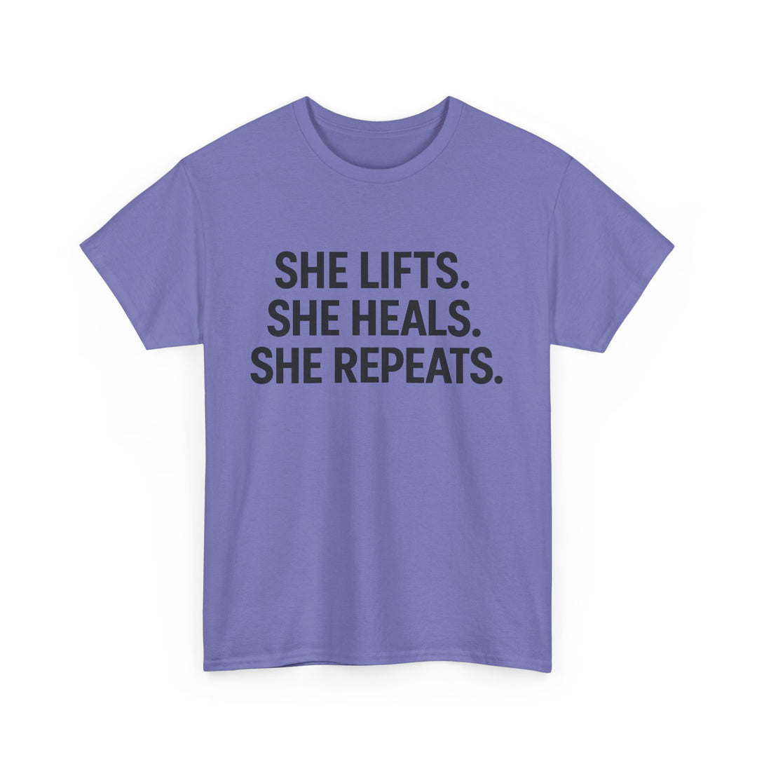 She Lifts. She Heals. She Repeats.  Unisex Heavy Cotton Tee
