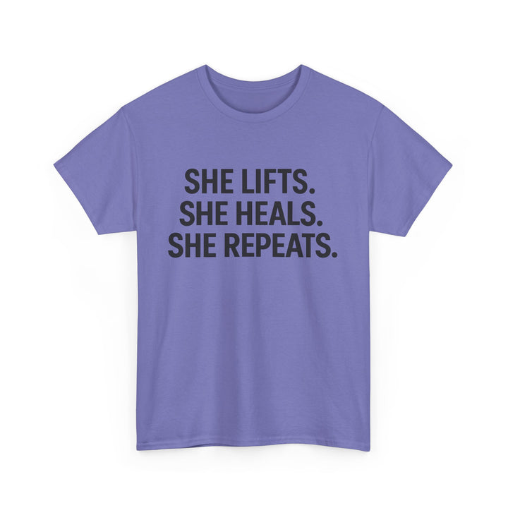 She Lifts. She Heals. She Repeats.  Unisex Heavy Cotton Tee