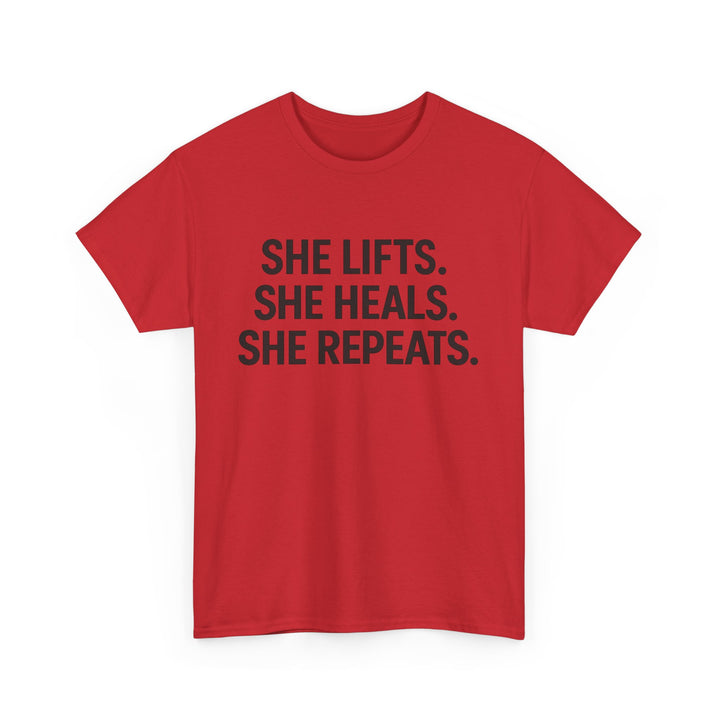 She Lifts. She Heals. She Repeats.  Unisex Heavy Cotton Tee
