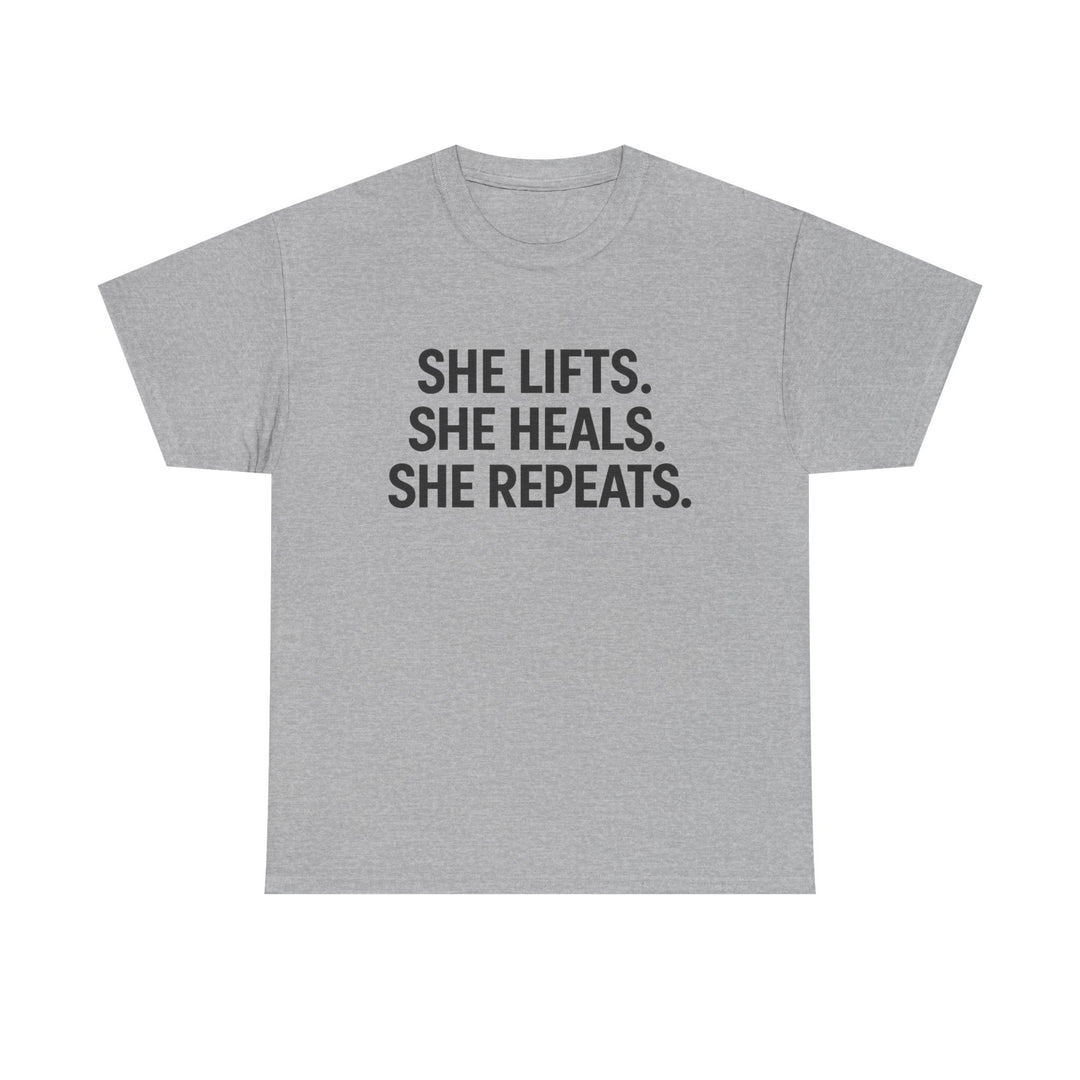 She Lifts. She Heals. She Repeats.  Unisex Heavy Cotton Tee