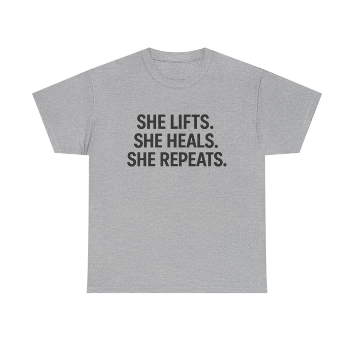 She Lifts. She Heals. She Repeats.  Unisex Heavy Cotton Tee