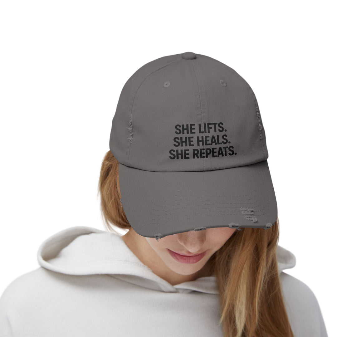 She Lifts. She Heals. She Repeats. : Unisex Distressed Cap