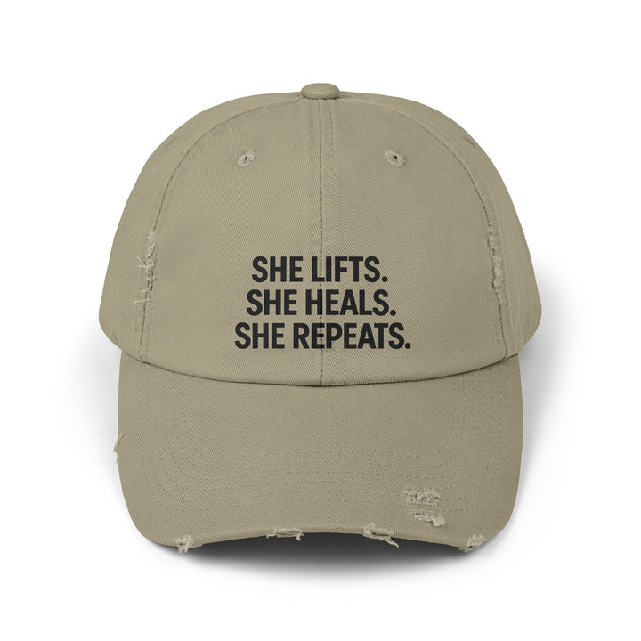 She Lifts. She Heals. She Repeats. : Unisex Distressed Cap