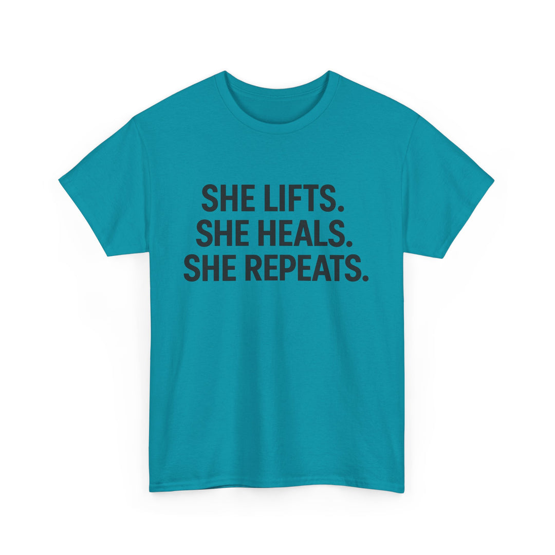 She Lifts. She Heals. She Repeats.  Unisex Heavy Cotton Tee