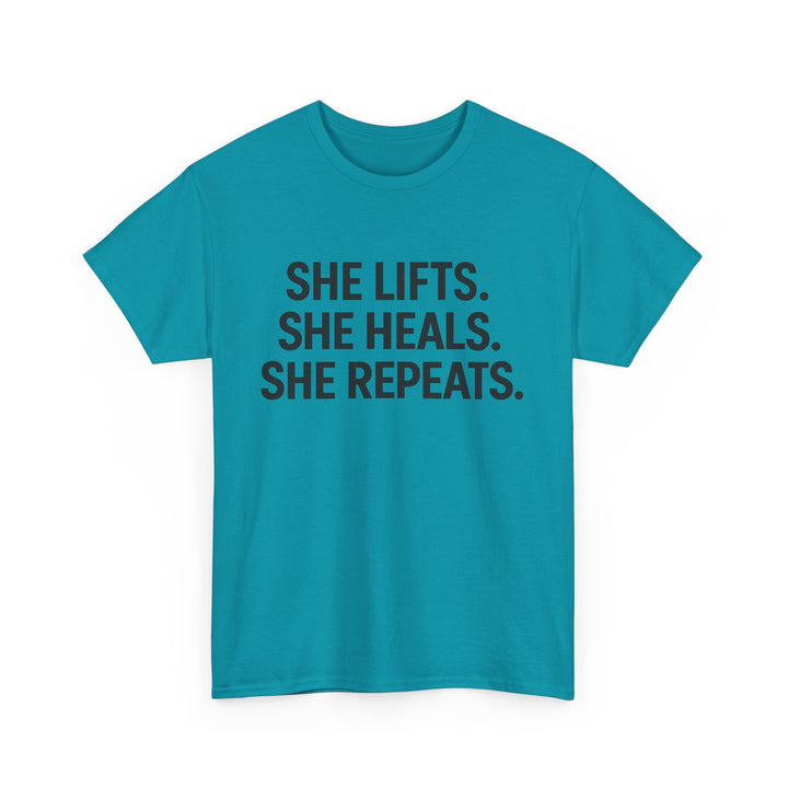 She Lifts. She Heals. She Repeats.  Unisex Heavy Cotton Tee
