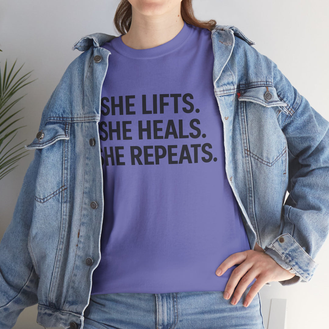 She Lifts. She Heals. She Repeats.  Unisex Heavy Cotton Tee