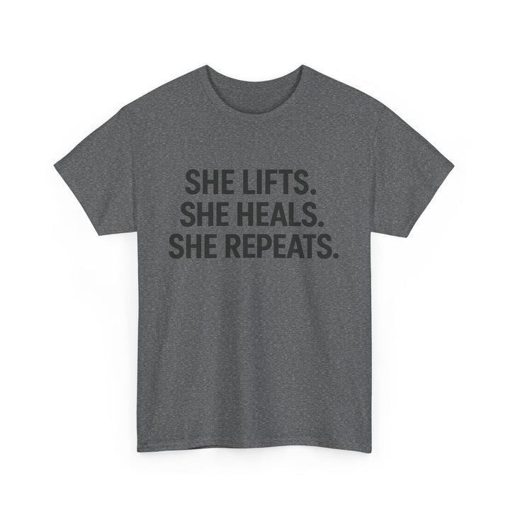 She Lifts. She Heals. She Repeats.  Unisex Heavy Cotton Tee