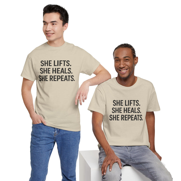 She Lifts. She Heals. She Repeats.  Unisex Heavy Cotton Tee