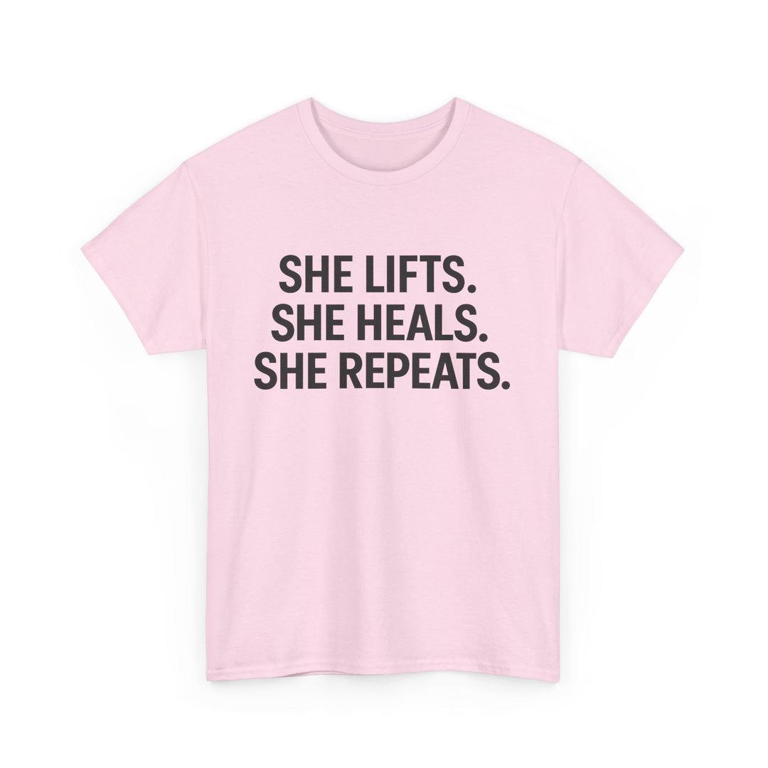 She Lifts. She Heals. She Repeats.  Unisex Heavy Cotton Tee