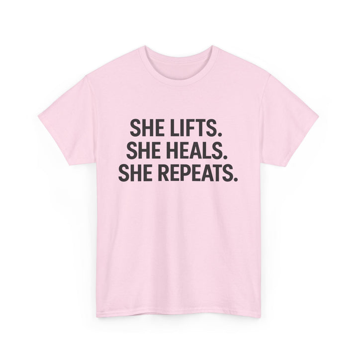 She Lifts. She Heals. She Repeats.  Unisex Heavy Cotton Tee