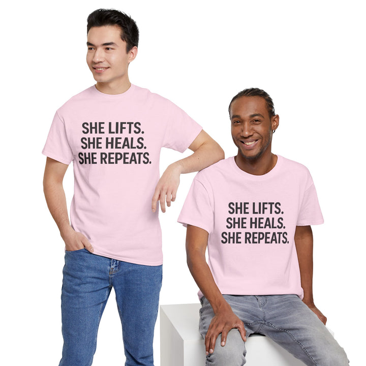 She Lifts. She Heals. She Repeats.  Unisex Heavy Cotton Tee