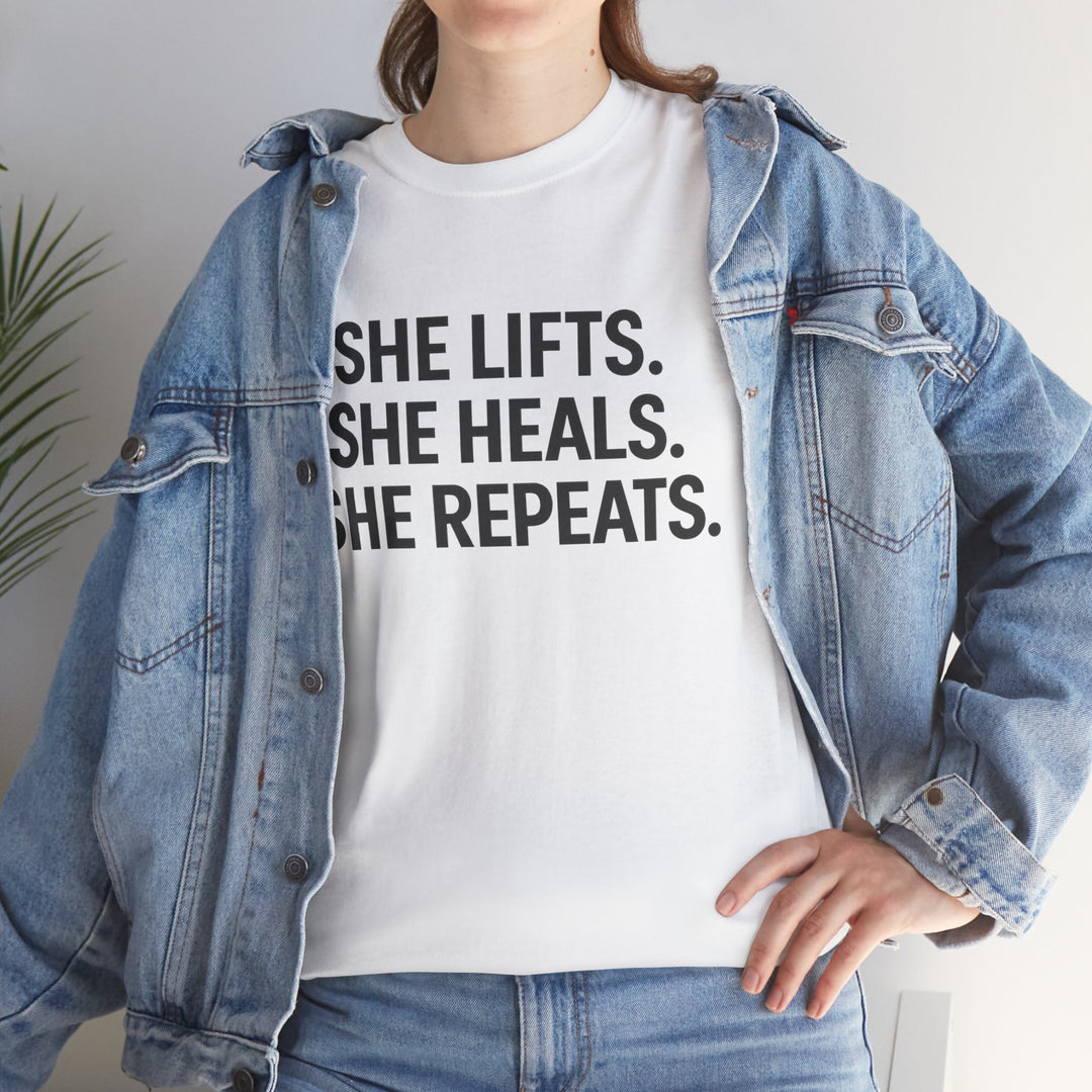 She Lifts. She Heals. She Repeats.  Unisex Heavy Cotton Tee