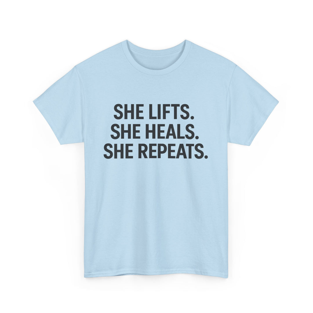 She Lifts. She Heals. She Repeats.  Unisex Heavy Cotton Tee