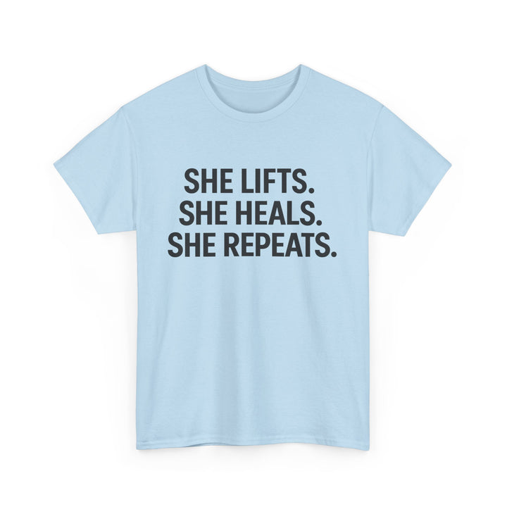 She Lifts. She Heals. She Repeats.  Unisex Heavy Cotton Tee