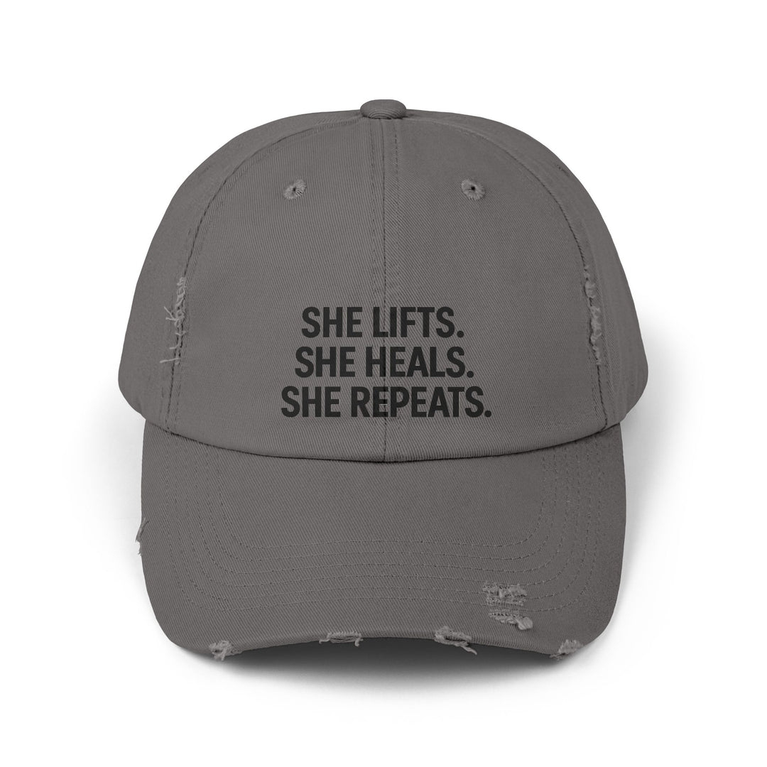 She Lifts. She Heals. She Repeats. : Unisex Distressed Cap