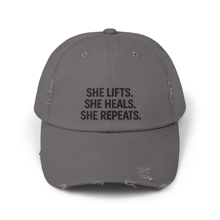 She Lifts. She Heals. She Repeats. : Unisex Distressed Cap