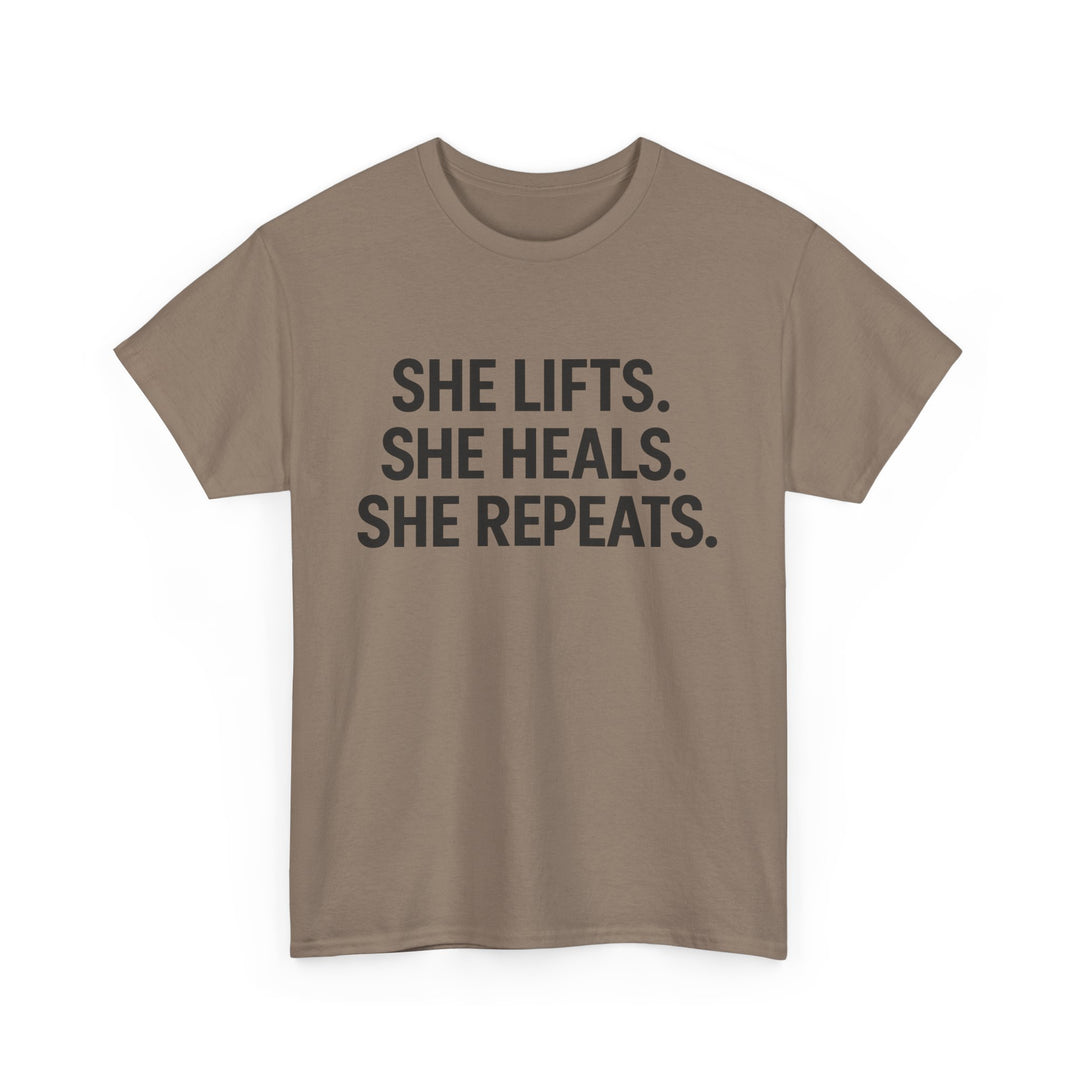 She Lifts. She Heals. She Repeats.  Unisex Heavy Cotton Tee