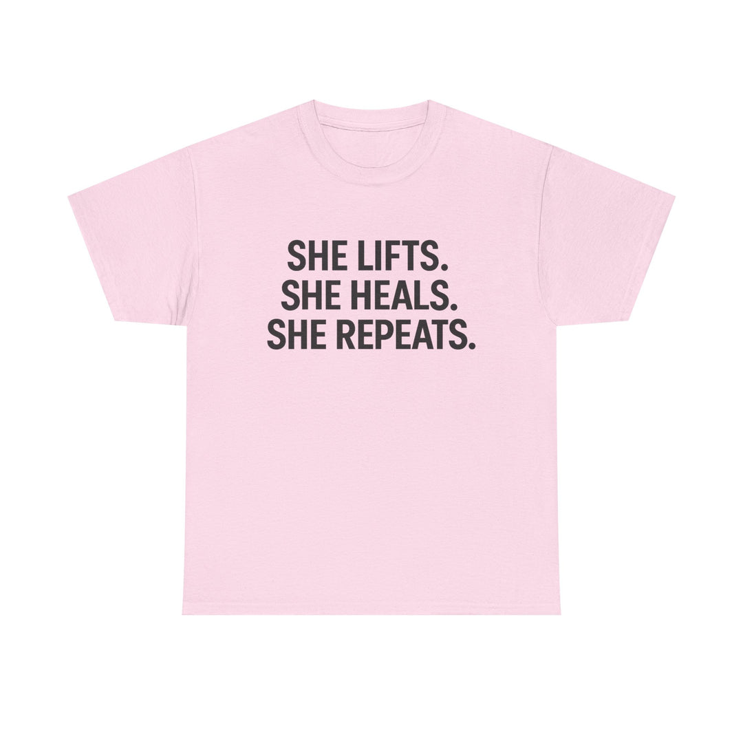 She Lifts. She Heals. She Repeats.  Unisex Heavy Cotton Tee