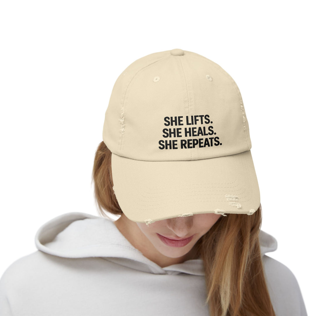 She Lifts. She Heals. She Repeats. : Unisex Distressed Cap