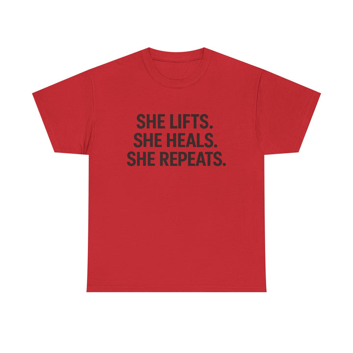 She Lifts. She Heals. She Repeats.  Unisex Heavy Cotton Tee