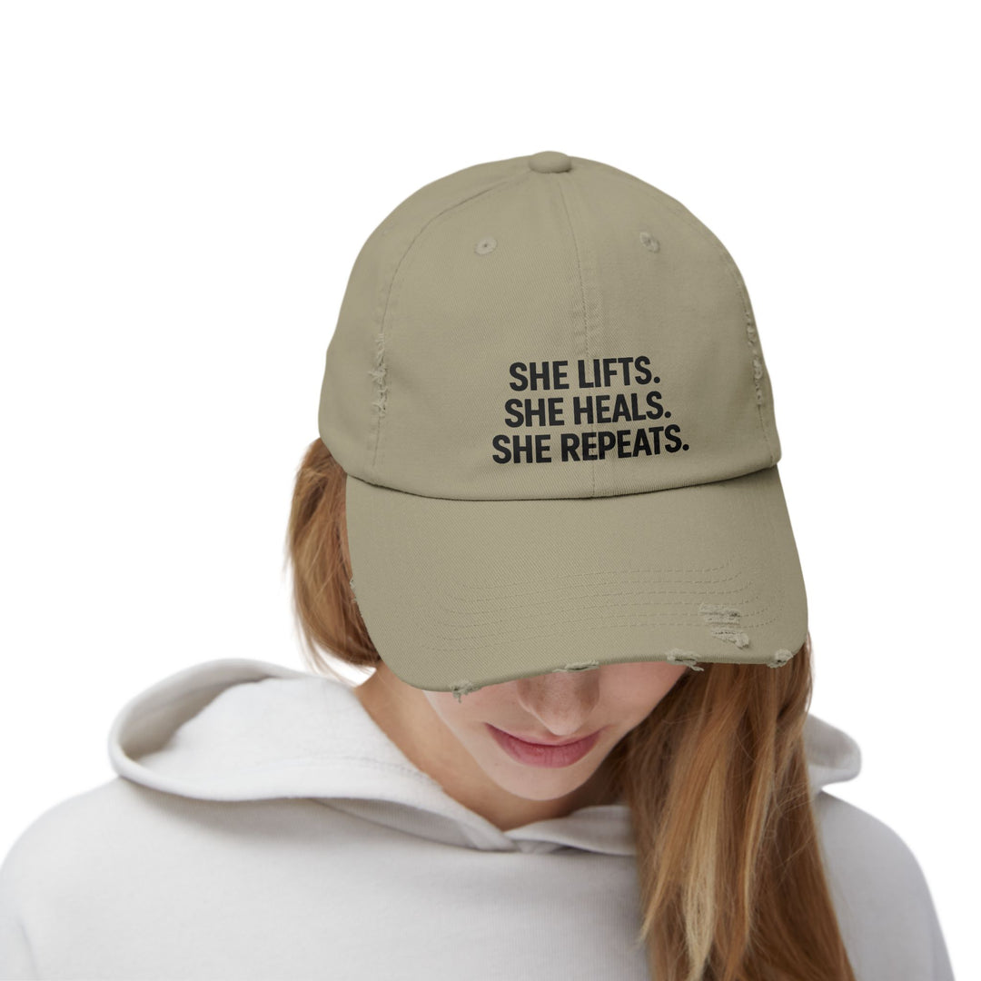 She Lifts. She Heals. She Repeats. : Unisex Distressed Cap