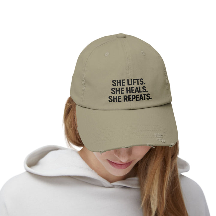She Lifts. She Heals. She Repeats. : Unisex Distressed Cap