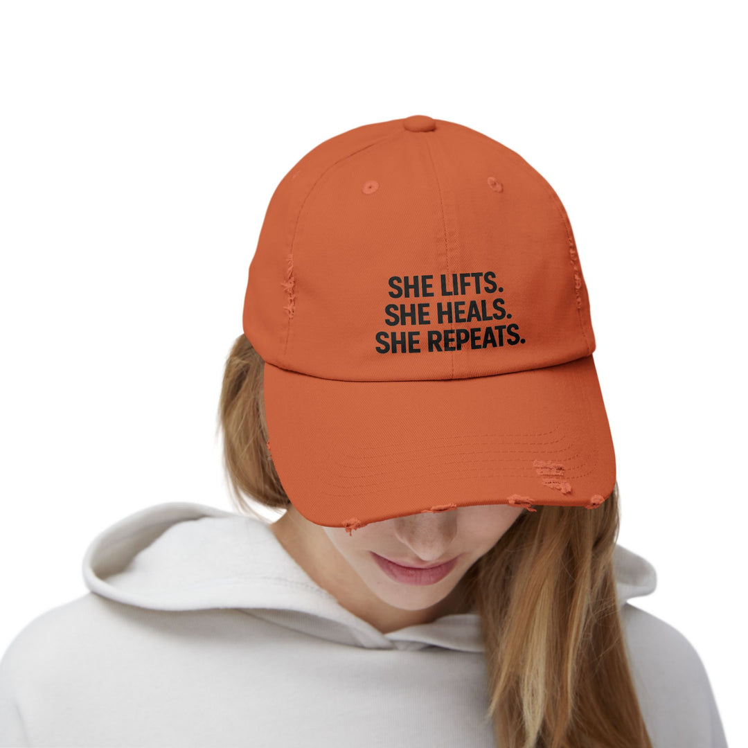She Lifts. She Heals. She Repeats. : Unisex Distressed Cap