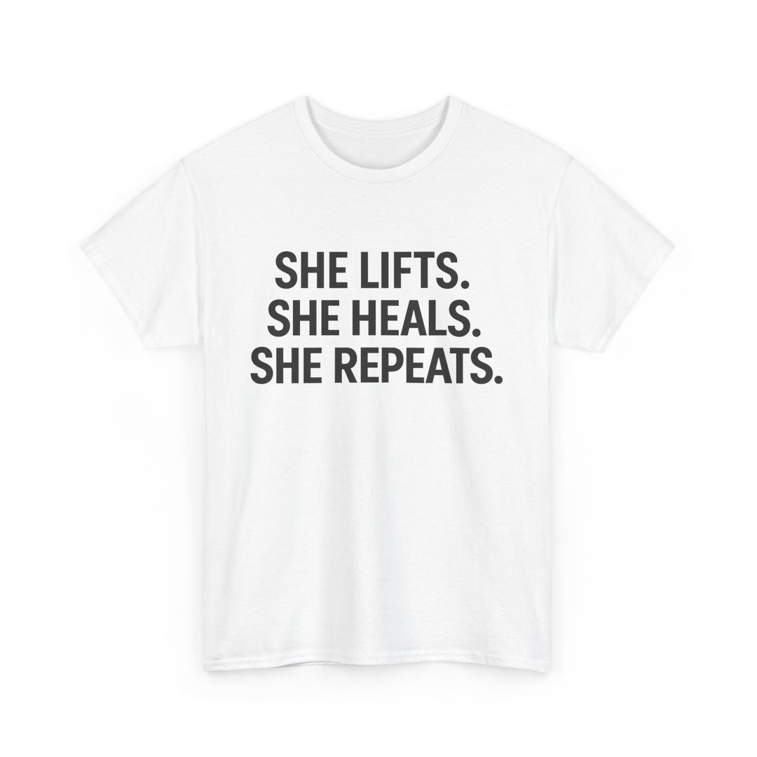 She Lifts. She Heals. She Repeats.  Unisex Heavy Cotton Tee