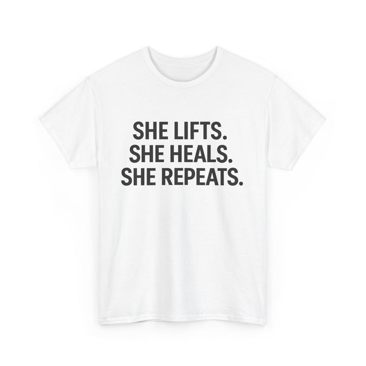 She Lifts. She Heals. She Repeats.  Unisex Heavy Cotton Tee