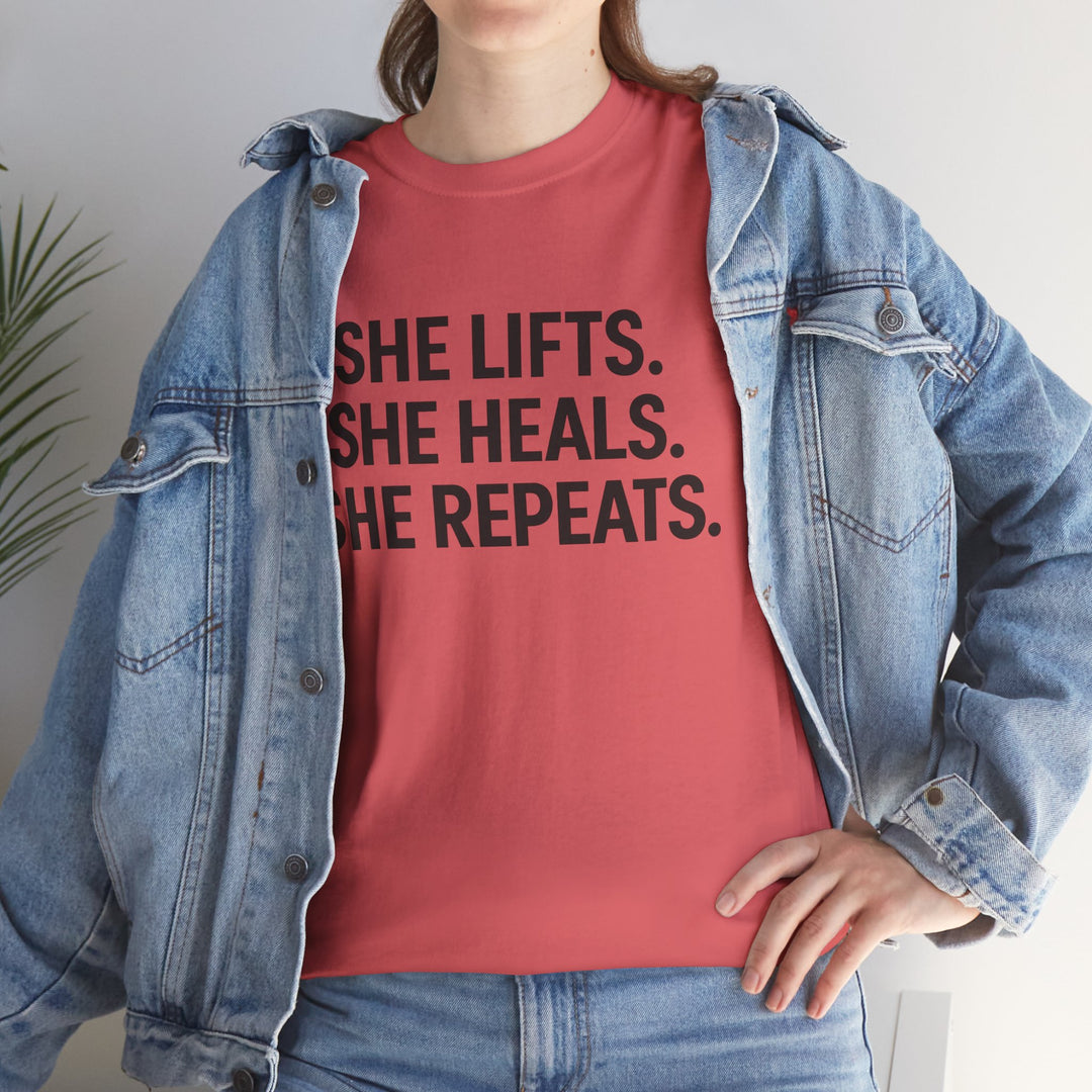 She Lifts. She Heals. She Repeats.  Unisex Heavy Cotton Tee