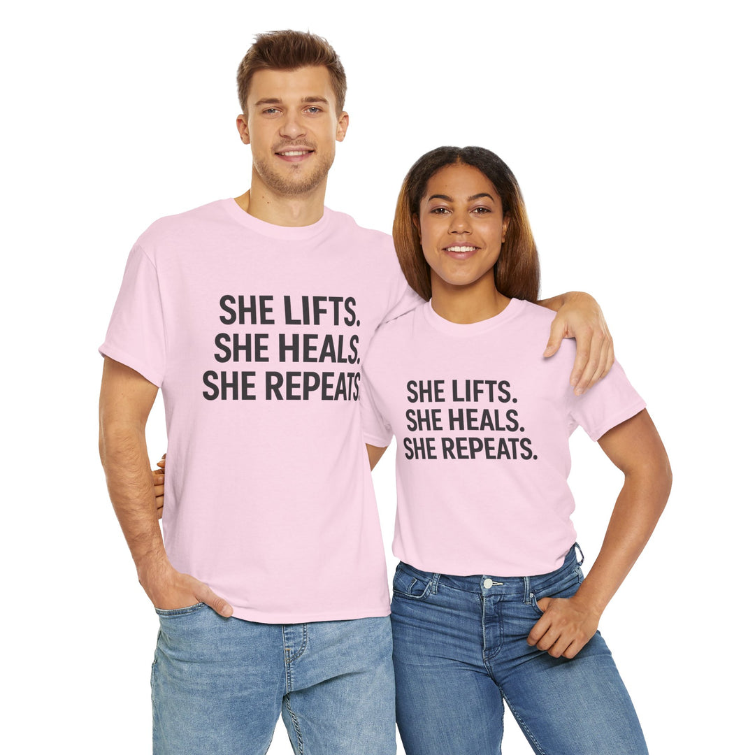 She Lifts. She Heals. She Repeats.  Unisex Heavy Cotton Tee