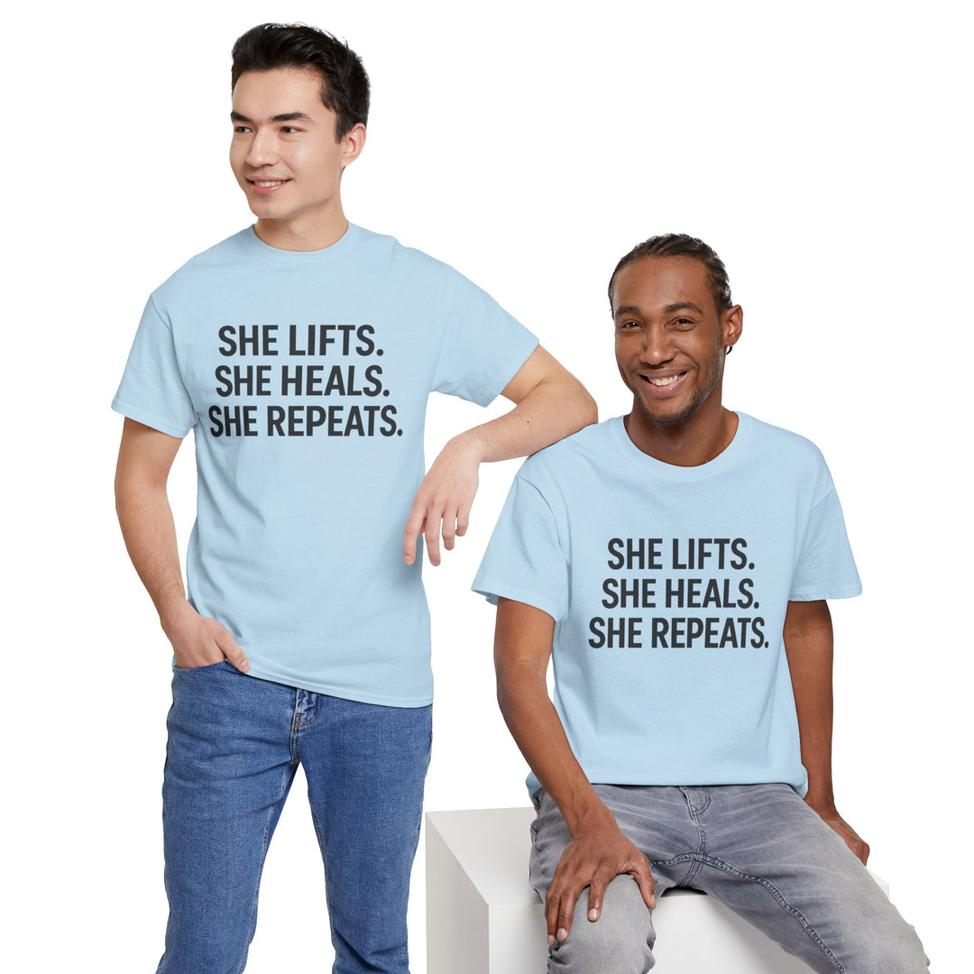 She Lifts. She Heals. She Repeats.  Unisex Heavy Cotton Tee