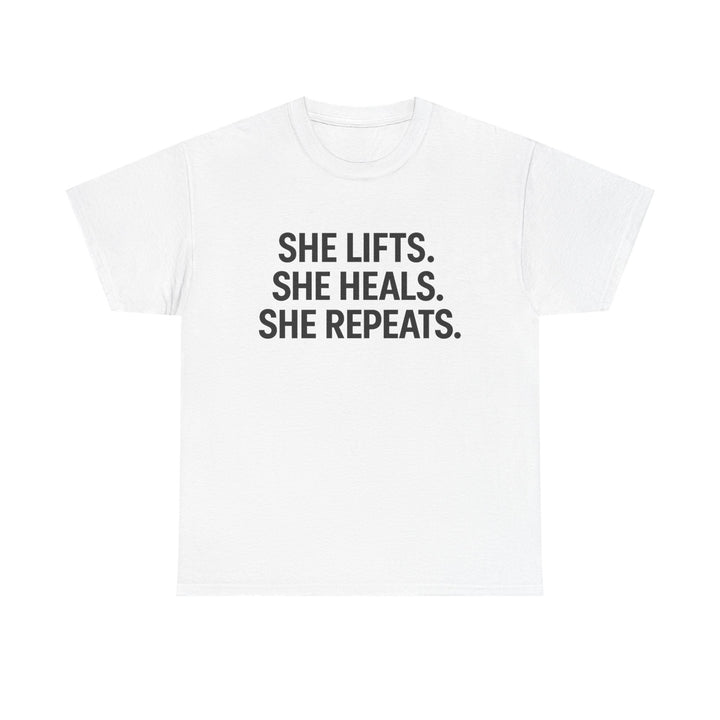 She Lifts. She Heals. She Repeats.  Unisex Heavy Cotton Tee