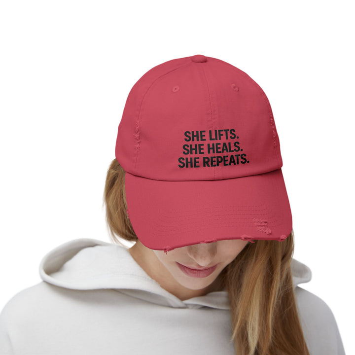 She Lifts. She Heals. She Repeats. : Unisex Distressed Cap