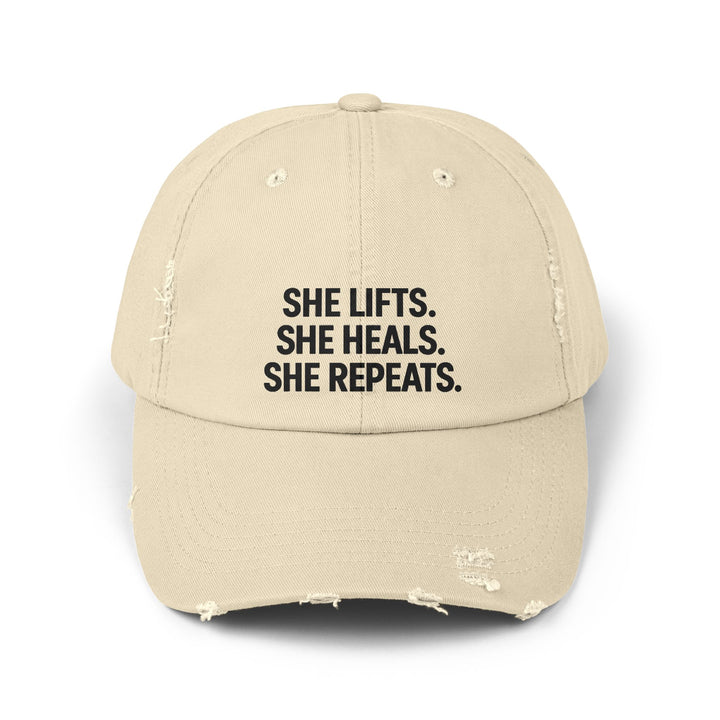 She Lifts. She Heals. She Repeats. : Unisex Distressed Cap