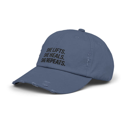 She Lifts. She Heals. She Repeats. : Unisex Distressed Cap