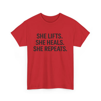 She Lifts. She Heals. She Repeats.  Unisex Heavy Cotton Tee