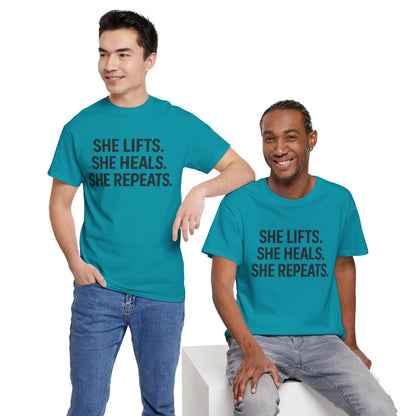 She Lifts. She Heals. She Repeats.  Unisex Heavy Cotton Tee