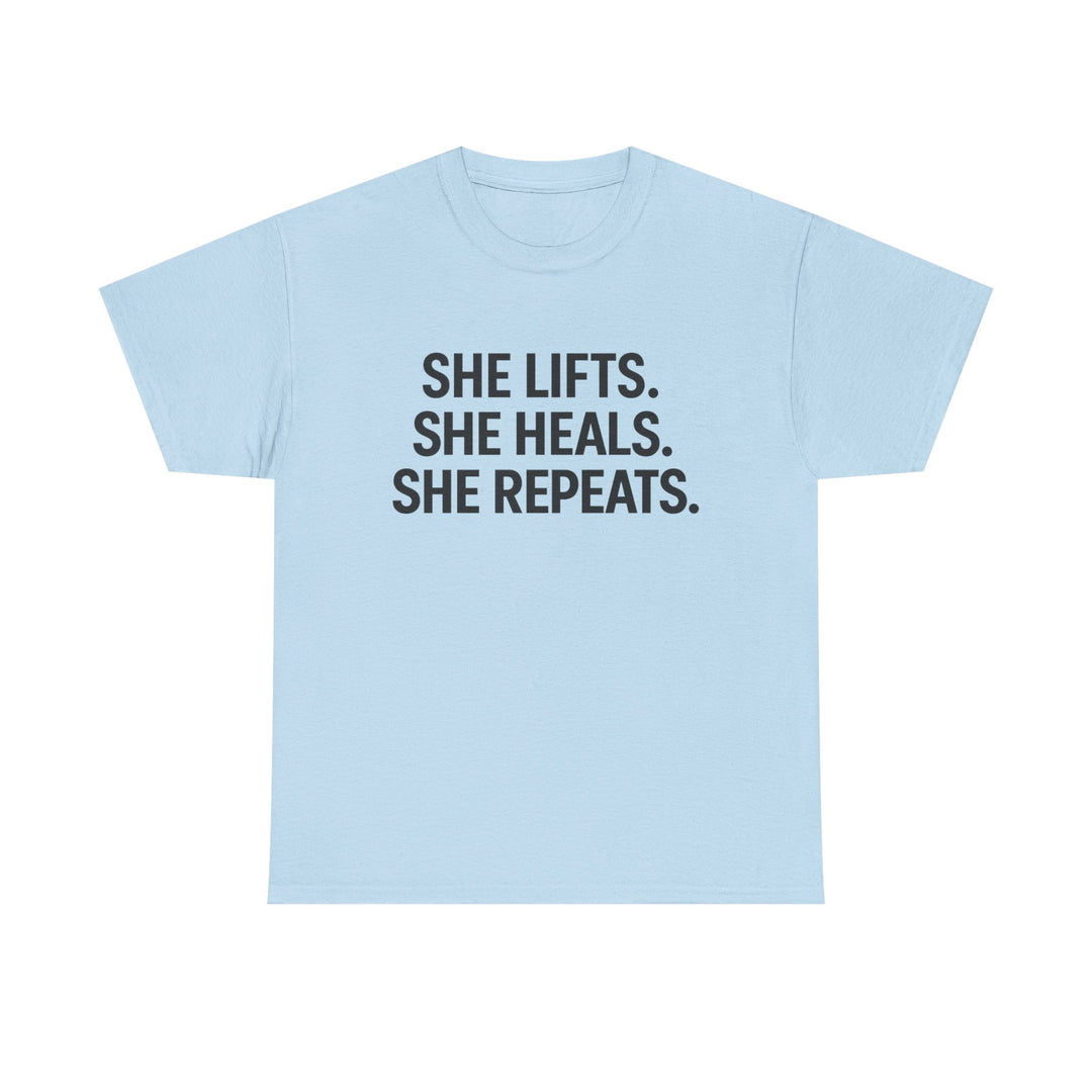 She Lifts. She Heals. She Repeats.  Unisex Heavy Cotton Tee