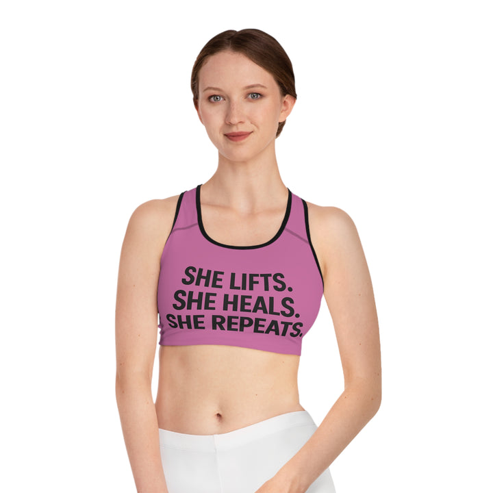 She Lifts. She Heals. She Repeats. Sports Bra