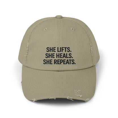 She Lifts. She Heals. She Repeats. : Unisex Distressed Cap