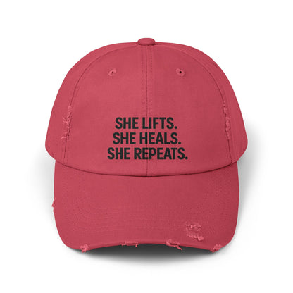 She Lifts. She Heals. She Repeats. : Unisex Distressed Cap