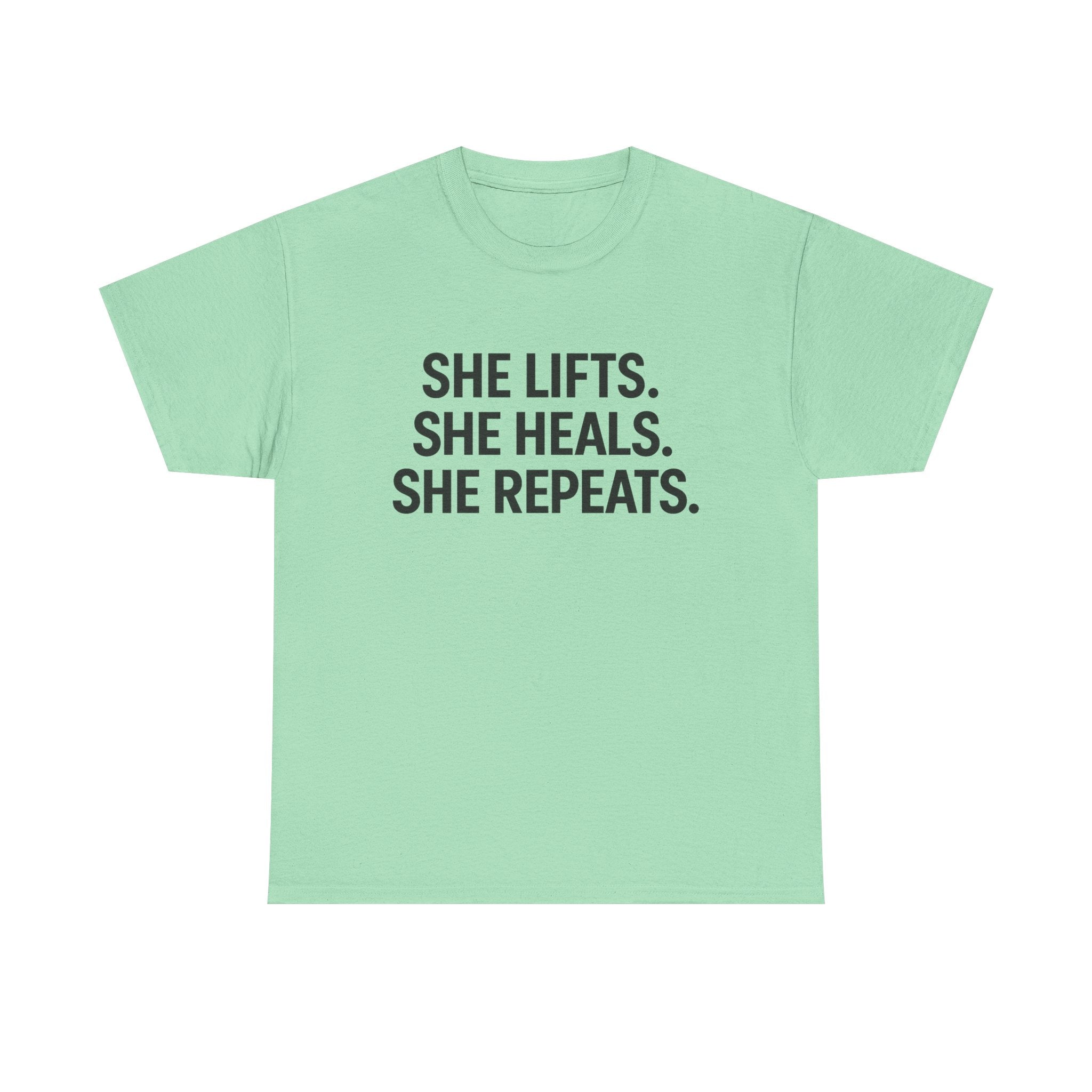She Lifts. She Heals. She Repeats.  Unisex Heavy Cotton Tee