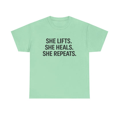 She Lifts. She Heals. She Repeats.  Unisex Heavy Cotton Tee