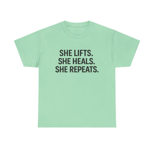 She Lifts. She Heals. She Repeats.  Unisex Heavy Cotton Tee