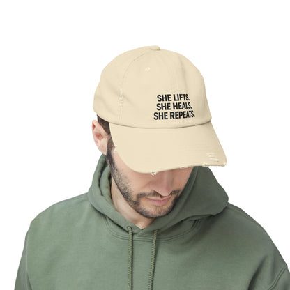 She Lifts. She Heals. She Repeats. : Unisex Distressed Cap