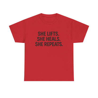 She Lifts. She Heals. She Repeats.  Unisex Heavy Cotton Tee