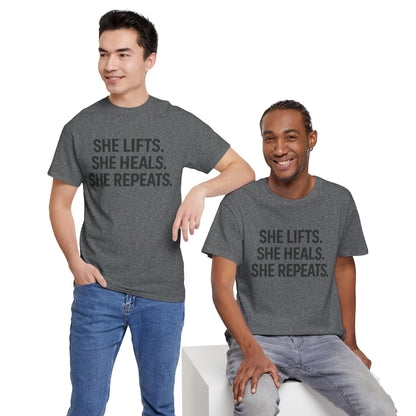 She Lifts. She Heals. She Repeats.  Unisex Heavy Cotton Tee