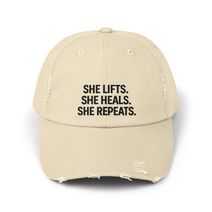 She Lifts. She Heals. She Repeats. : Unisex Distressed Cap