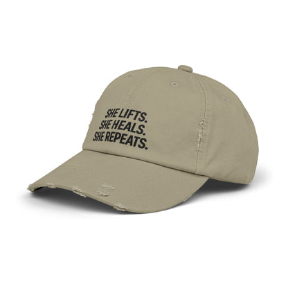 She Lifts. She Heals. She Repeats. : Unisex Distressed Cap